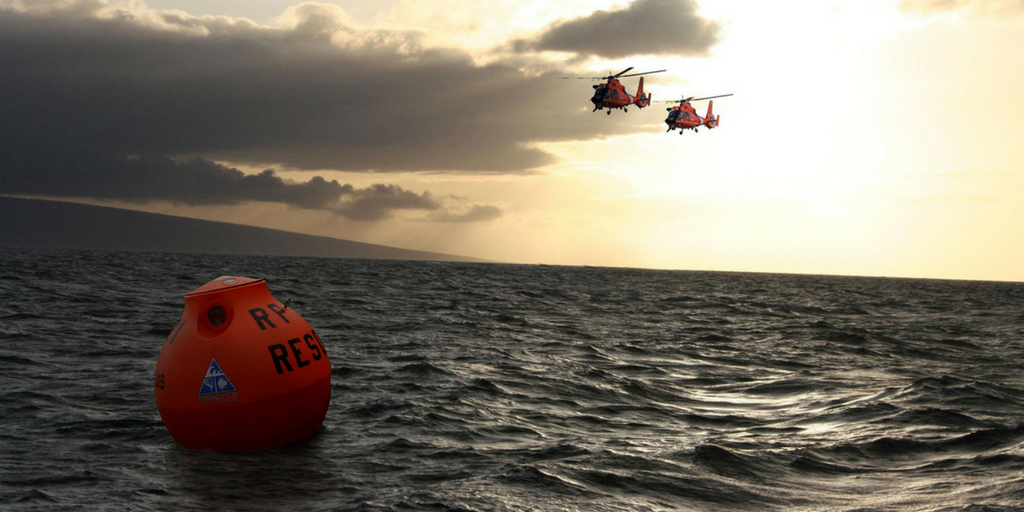 A RescuePod bobs on the water as the Coast Guard approaches.